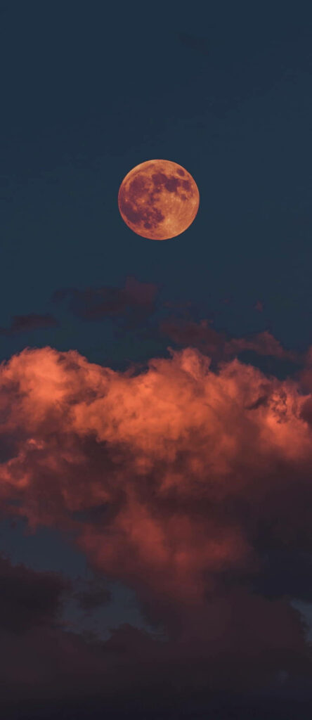 Crimson Sky: Capturing the Majesty of a Red-tinged Evening Moon with iPhone 11 Pro's Red Background Wallpaper