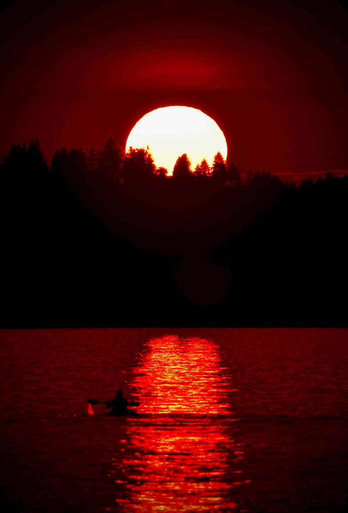 Red Moon Wallpaper: Serene Lake Scene with Silhouette and Boat