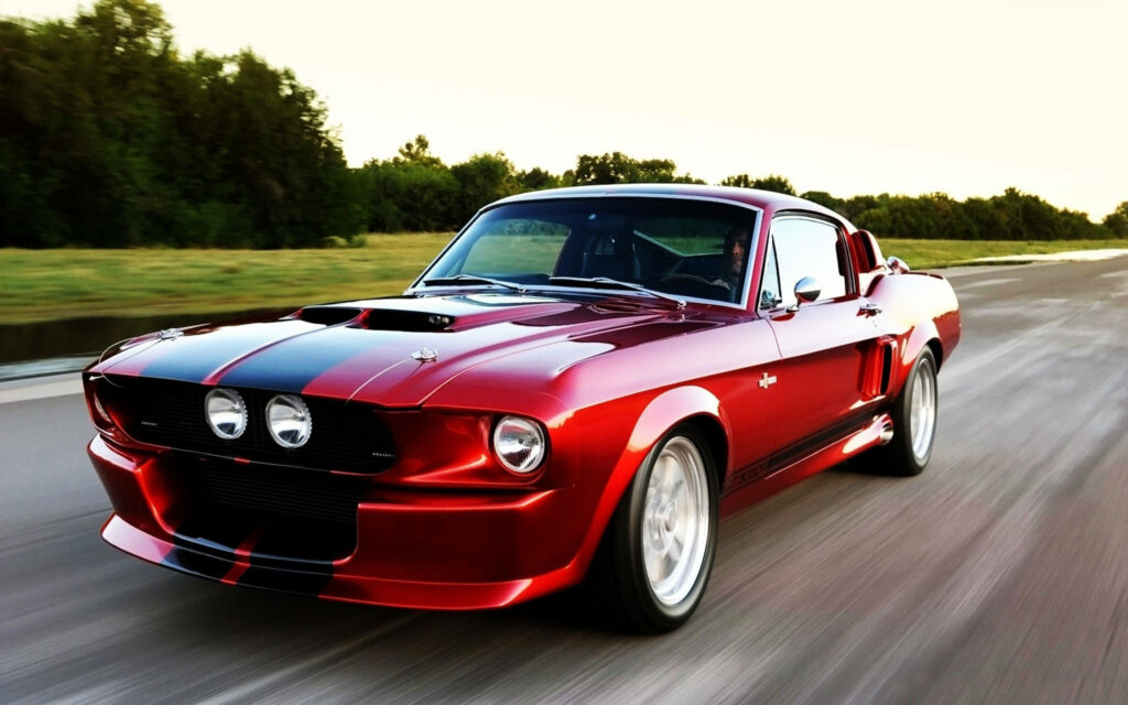 Red Mustang muscle car speeding on open road shining under sunlight 4K Ultra HD wallpaper