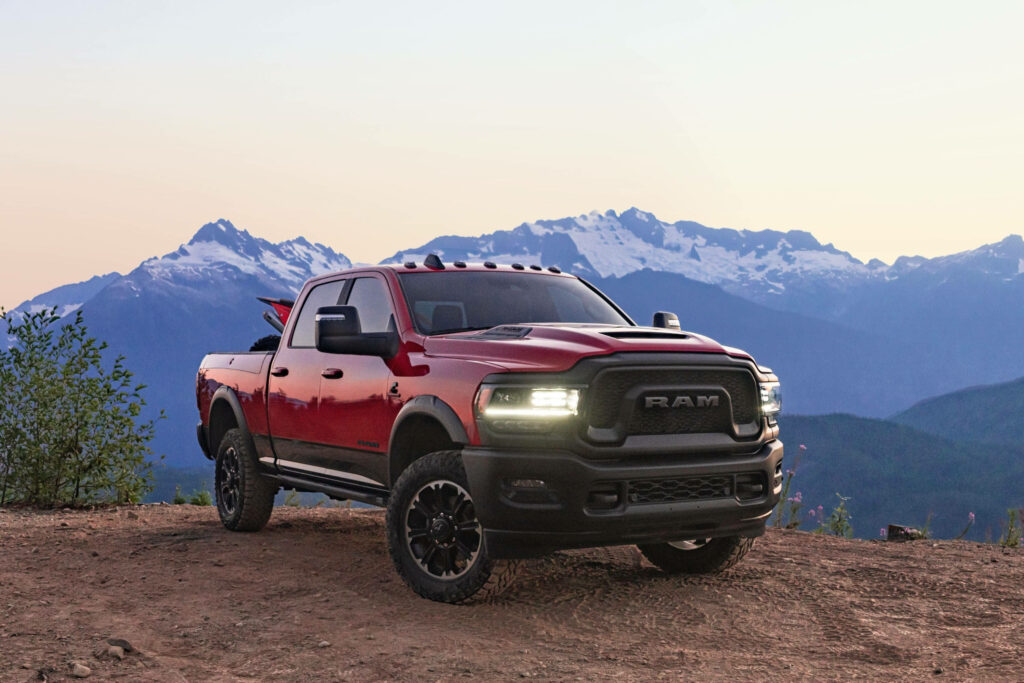 Red RAM Truck Wallpaper: Rugged Adventure with Snowy Mountains