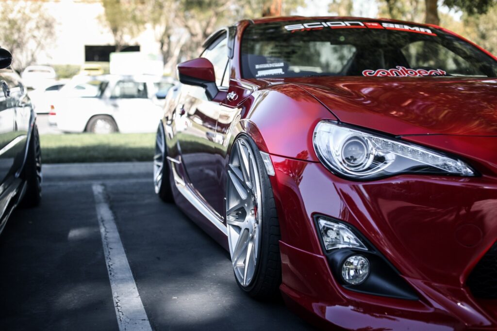 Sleek Red Sports Car Wallpaper: Glossy Supercar Design on Street