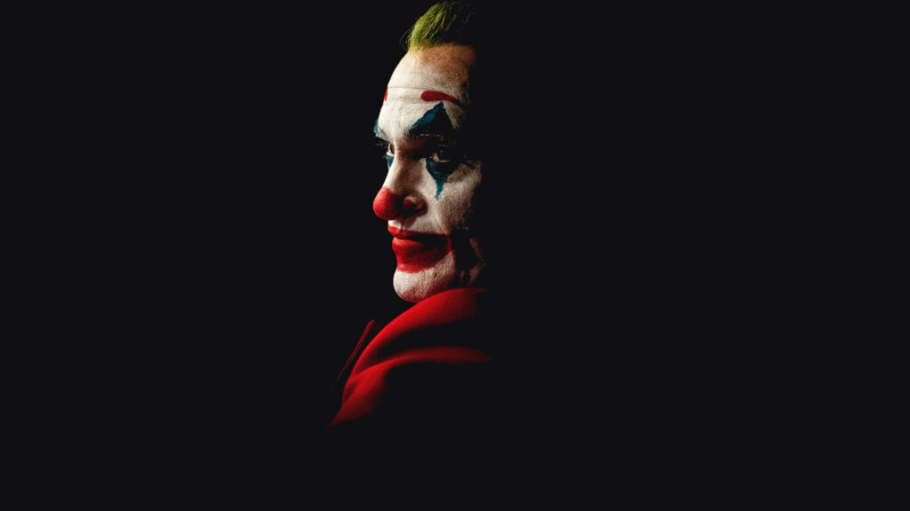 Joaquin Phoenix Joker portrait with green hair red suit dark moody cinematic high contrast wallpaper