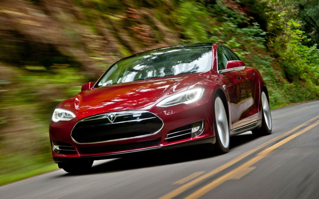 Cruising through Mother Nature: Red Tesla Model S Speed Wallpaper