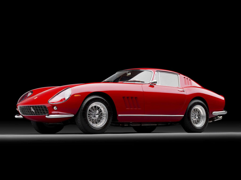 Cruising in Style: Captivating Vintage Ferrari Roaming Against a Mysterious Backdrop Wallpaper
