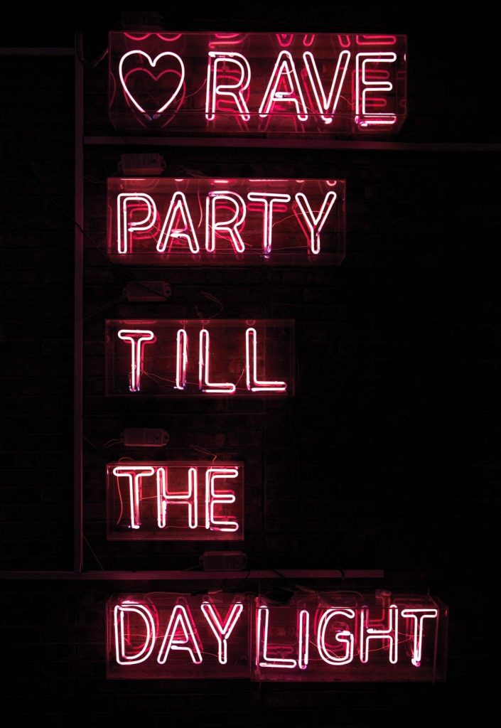 Red and black neon rave party till the daylight sign on dark brick wall wallpaper background