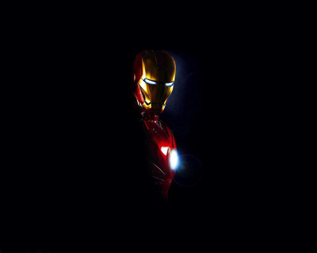Red-Lit Heroism: Iron Man's Iconic Half-Body Pose amidst a Mysterious Black Background Wallpaper