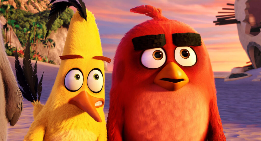 Red and Chuck from Angry Birds on beach at vibrant sunset wallpaper background