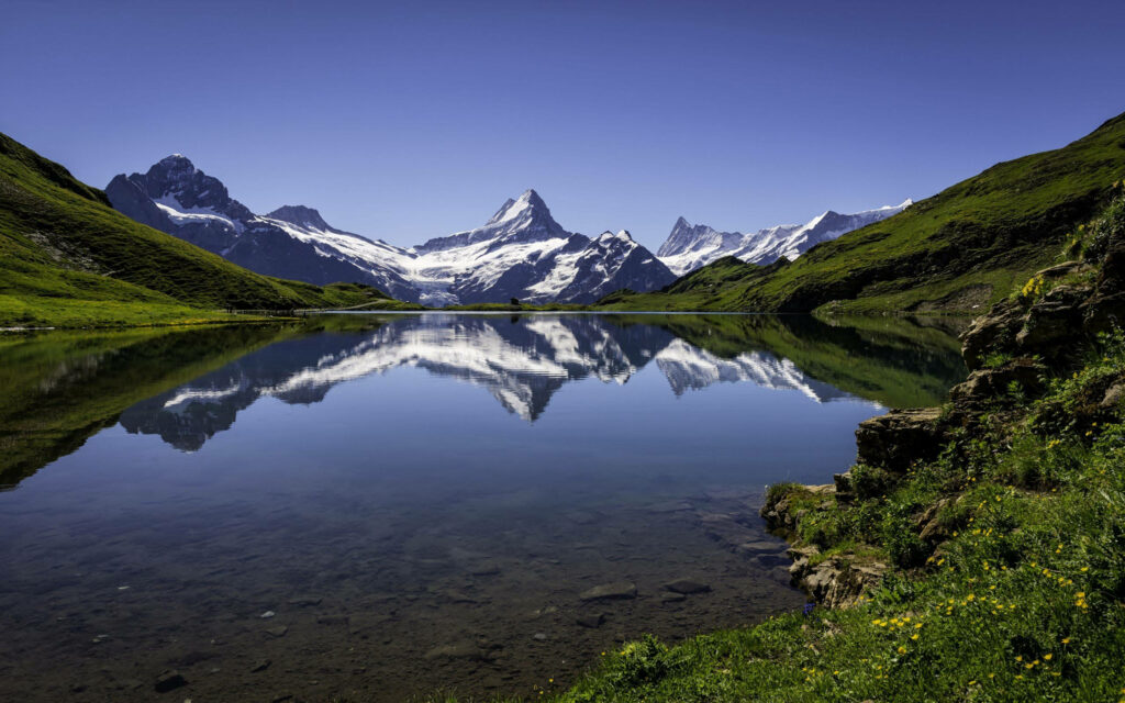 A Serene Landscape: Majestic Mountains and Tranquil River in 4K Nature Photo  Wallpaper