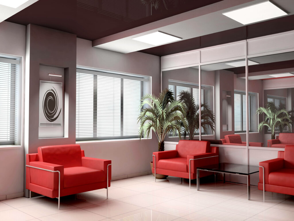 Reflecting Serenity: Zoom into a Sleek Office Ambiance with Vibrant Red Sofas Wallpaper