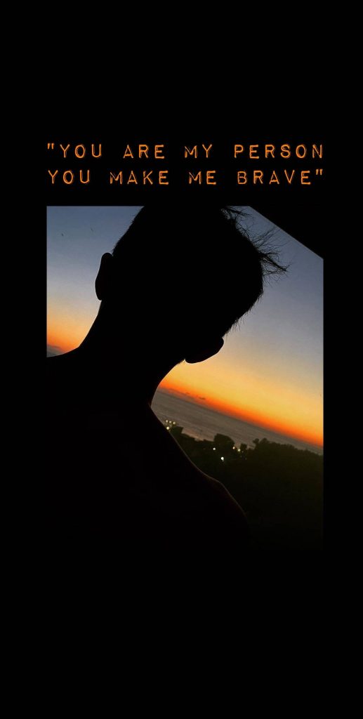 Silhouette gazing at orange sunset over ocean with inspiring You are my person quote wallpaper