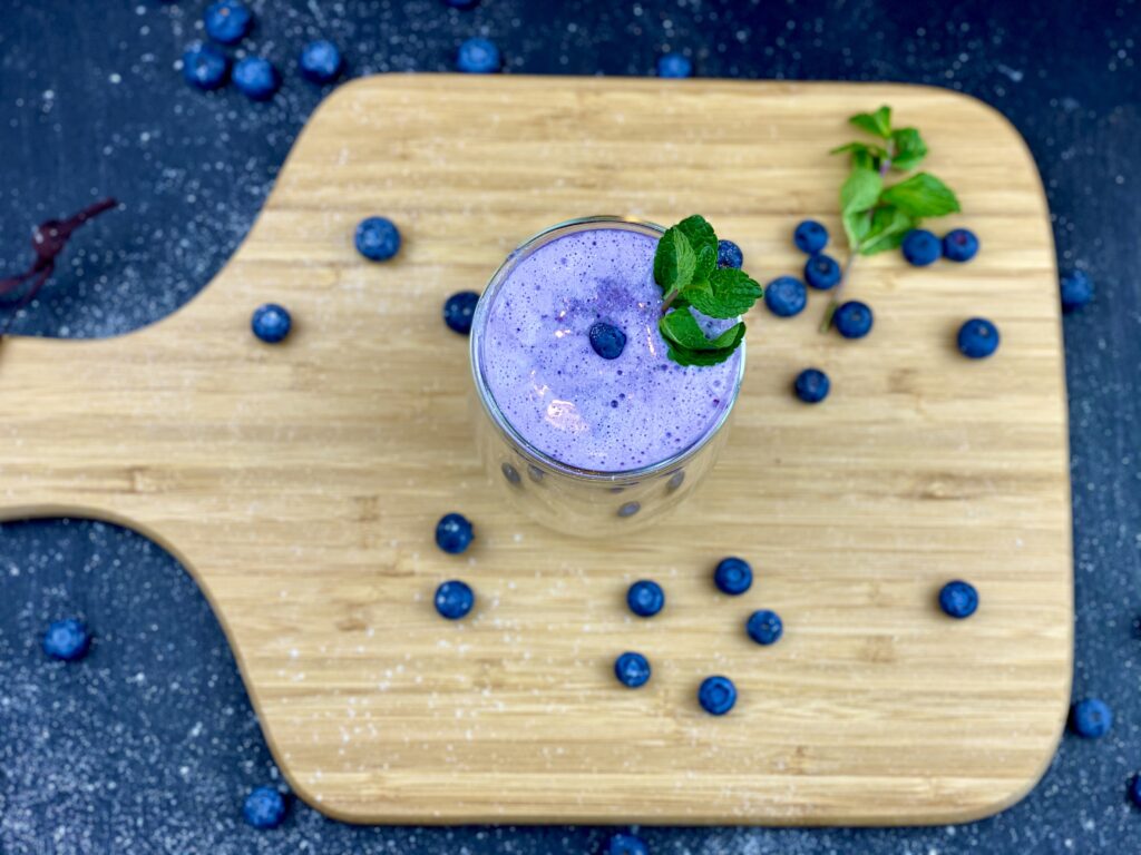 Refreshing Blueberry Smoothie with Mint on Wooden Board Wallpaper