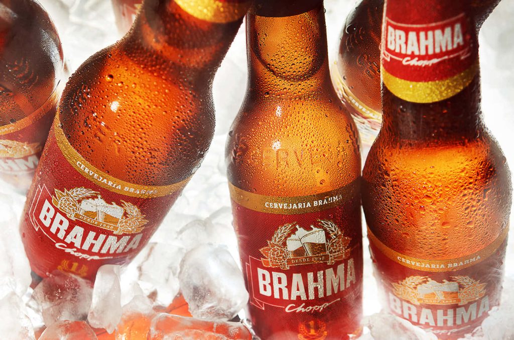 Brahma Chopp Pilsen beer wallpaper with amber bottles in ice and vibrant red branding background