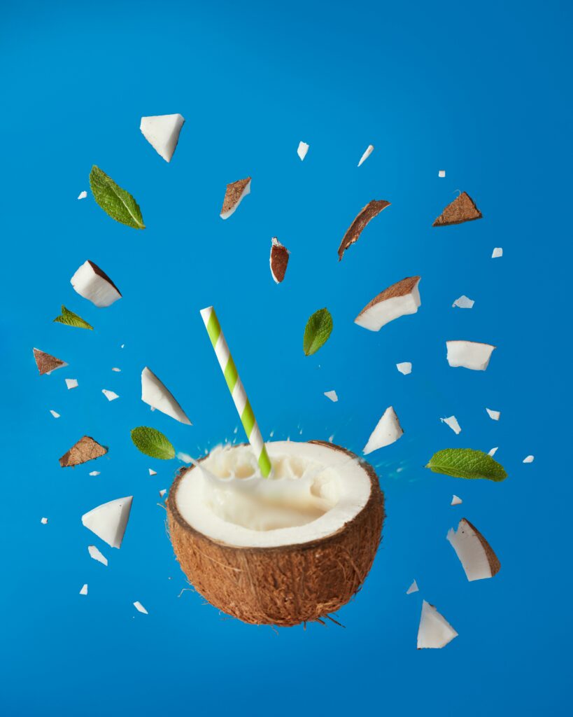 Refreshing Coconut Cocktail Wallpaper with Mint and Vibrant Blue Background