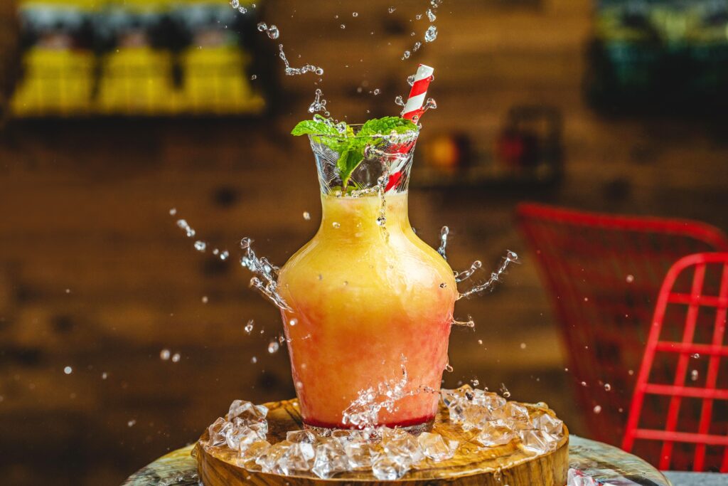 Vibrant Beverage Jug with Mint & Ice Splash Wallpaper Background
