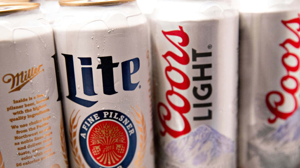 Close-up Coors Light and Miller Lite cans with condensation showcasing classic cold beer branding Wallpaper