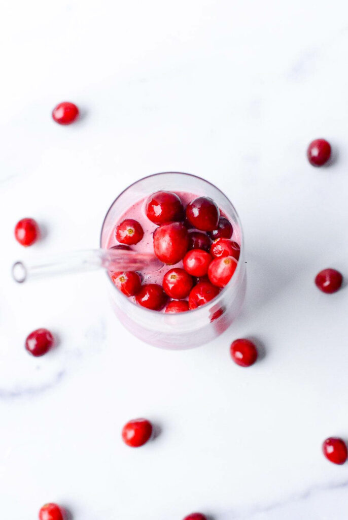 Fresh Cranberry Juice Wallpaper on White Surface - Vibrant & Refreshing