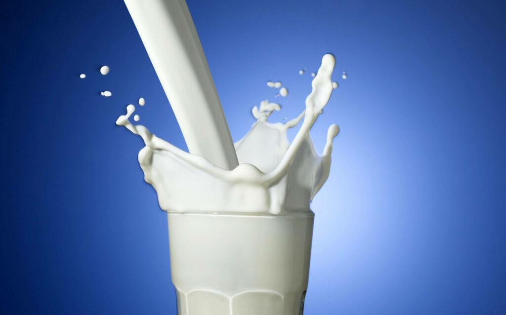 Refreshing Dairy Milk Splash Wallpaper on Vibrant Blue Background