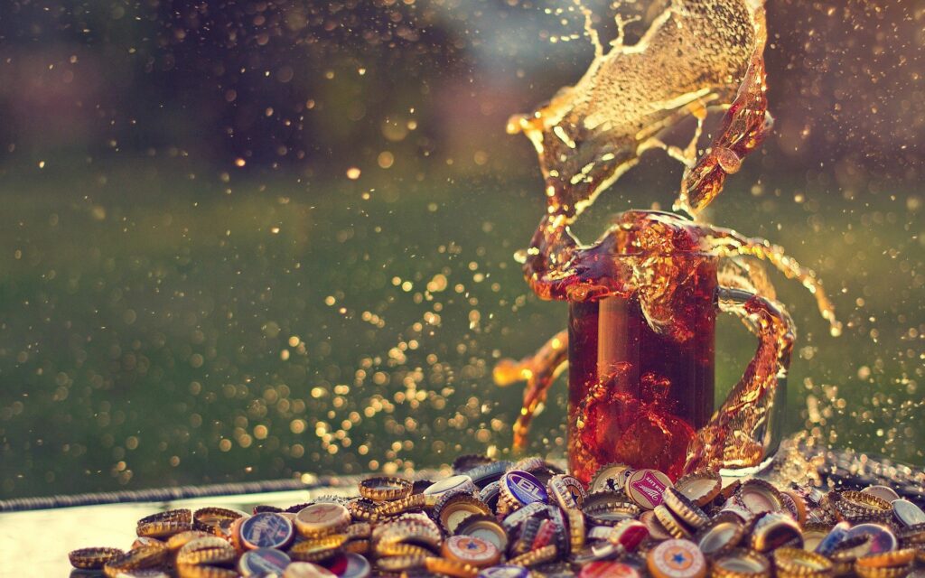 Refreshing Drink Splash Macro: Colorful Bottles & Dynamic Background Wallpaper