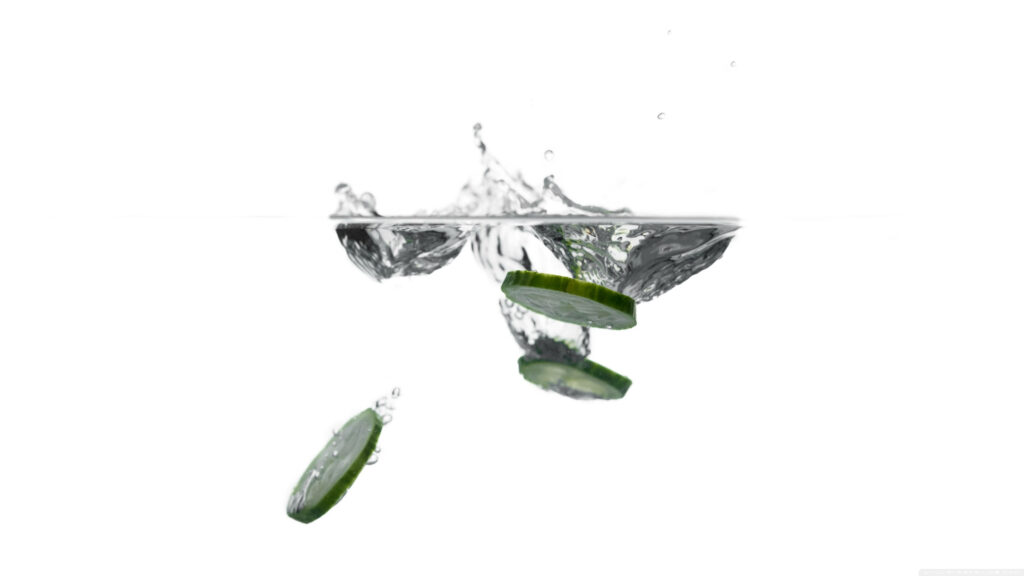 Refreshing Gherkin Splash Wallpaper – Minimalist White Background