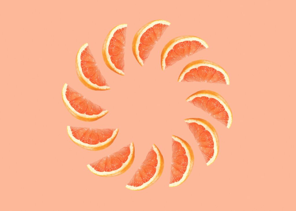 Vibrant Grapefruit Slice Wallpaper: Peach Background Delight