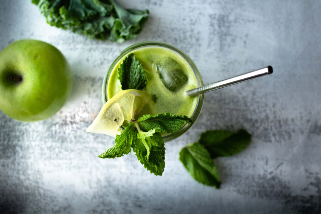 Refreshing Green Smoothie with Mint & Lemon on Aesthetic Background Wallpaper