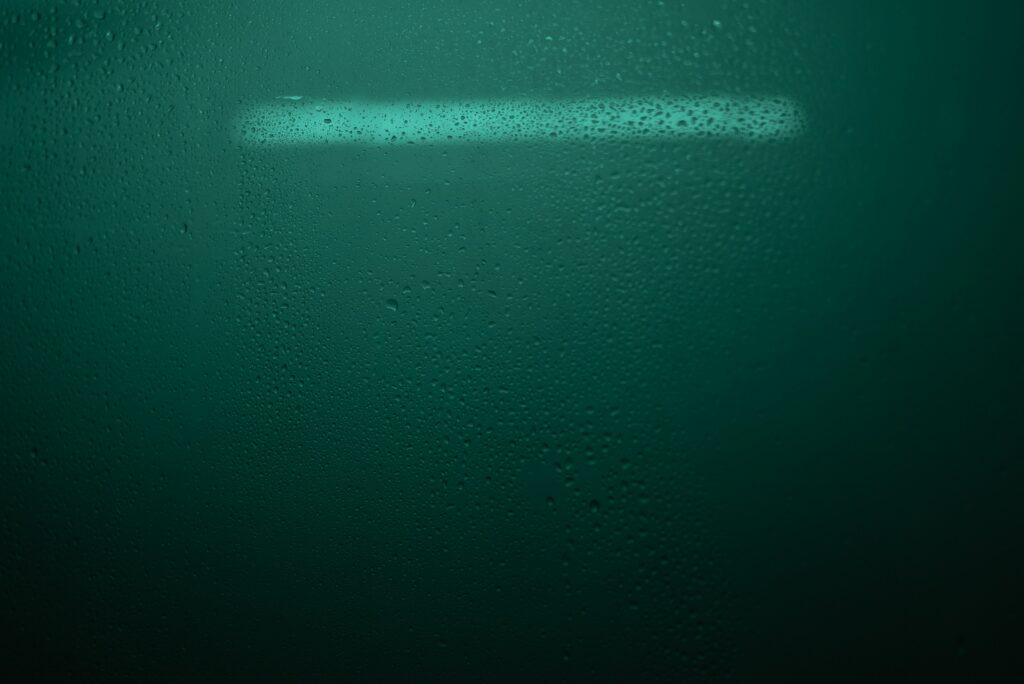 Refreshing Green Water Droplets on Glass - Wallpaper Background