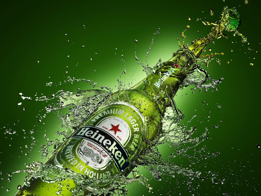 Chilled Heineken Beer Wallpaper with Splashing Water on Green Background