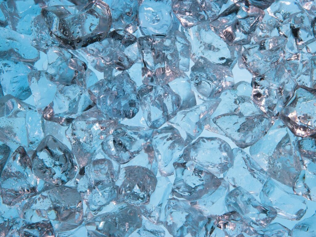 Refreshing Wallpaper: Transparent Ice Cubes on Blue Background