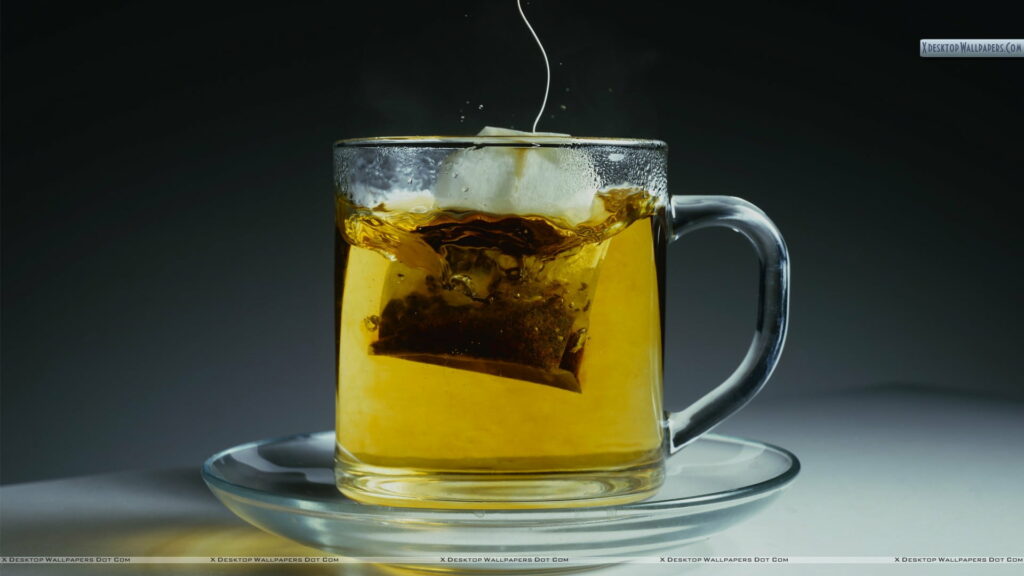 Refreshing Summer Sip: A Crystalline View of Iced Tea in Transparent Glass Wallpaper
