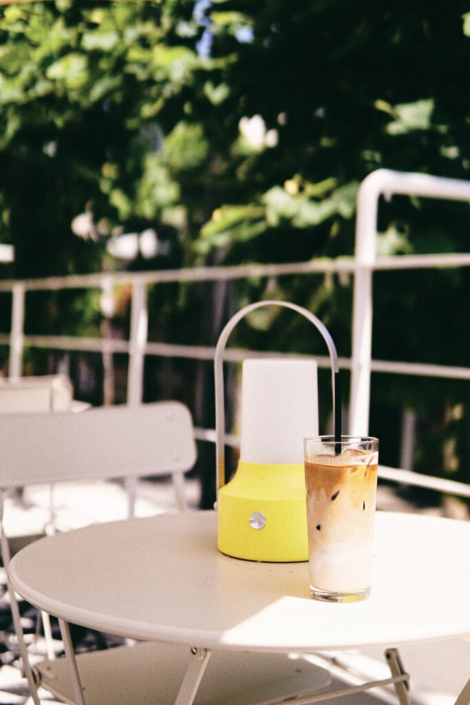 Refreshing Iced Coffee Wallpaper: Serene Outdoor Greenery & Lamp