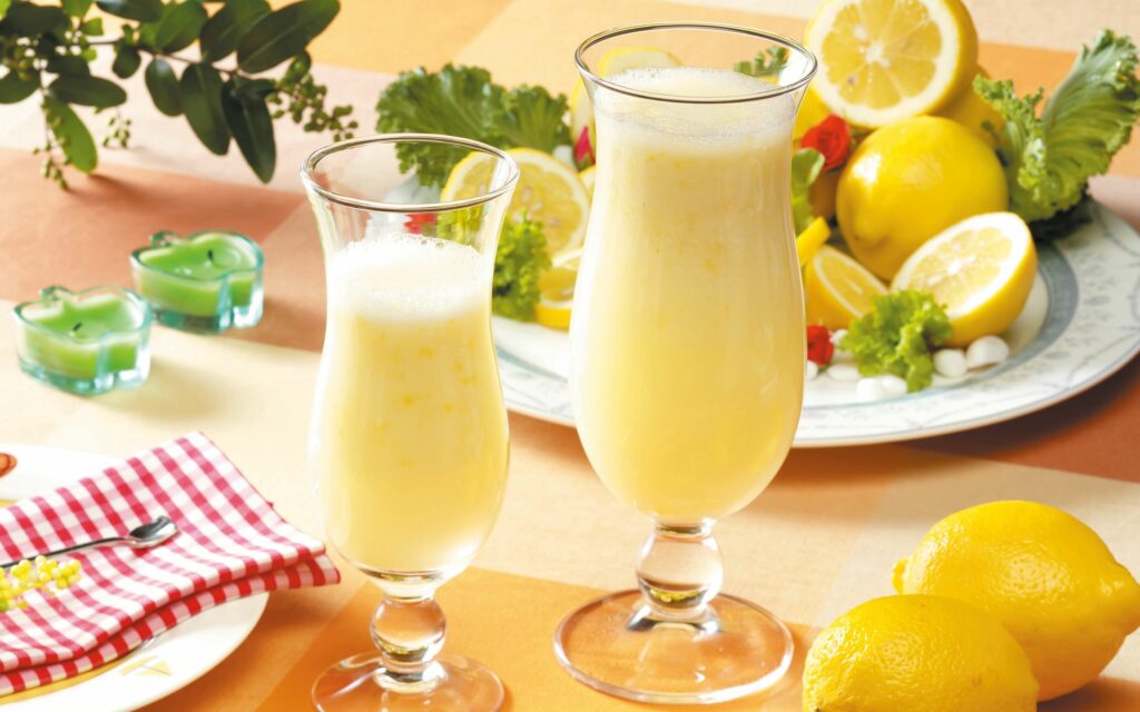 Cheerful Lemon Drink Wallpaper: Elegant Glasses & Fresh Lemons