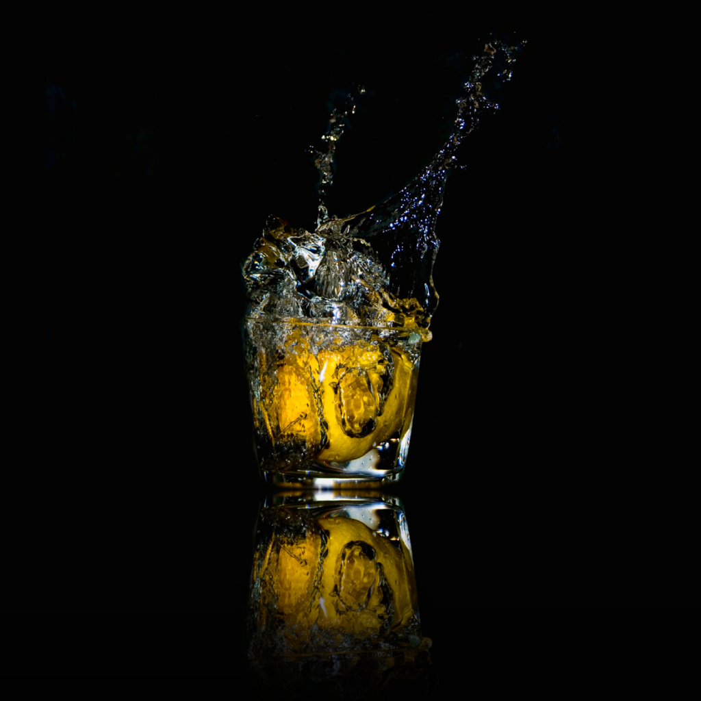 Dynamic Lemon Splash Wallpaper: Macro Water Art on Black Background