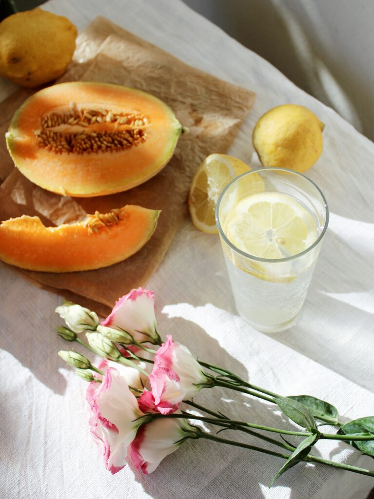 Refreshing Lemonade Still Life with Melons & Flowers - Wallpaper Background
