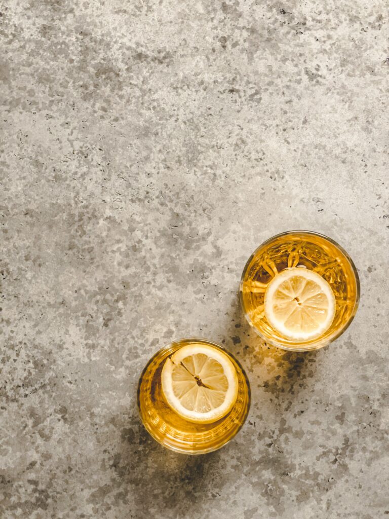 Refreshing Lemonade Wallpaper with Lemon Slices on Gray Background