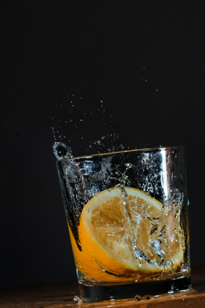 Vibrant Lemonade Splash Wallpaper - Refreshing Dark Background Art