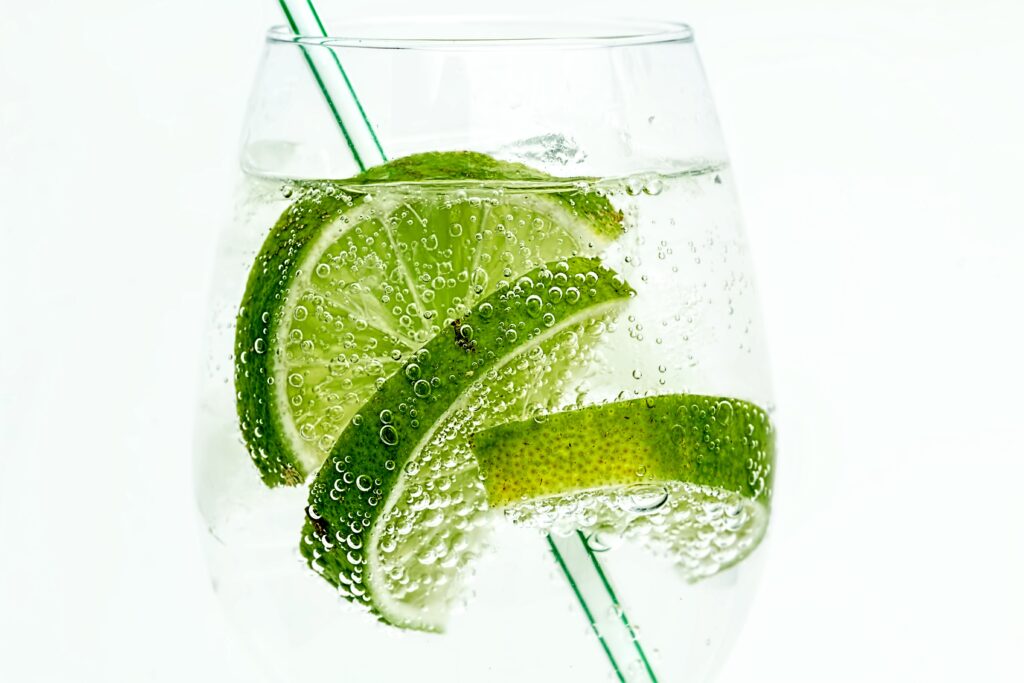 Refreshing Lime Slice Wallpaper in Sparkling Drink Background