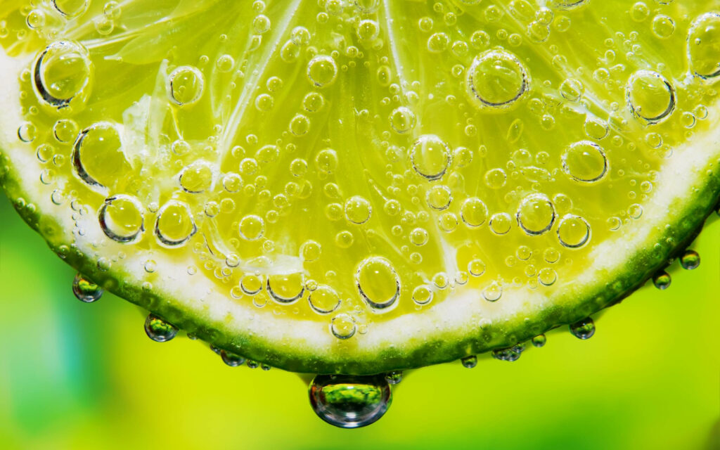 Refreshing Lime Slice with Sparkling Soda Bubbles - Green Wallpaper