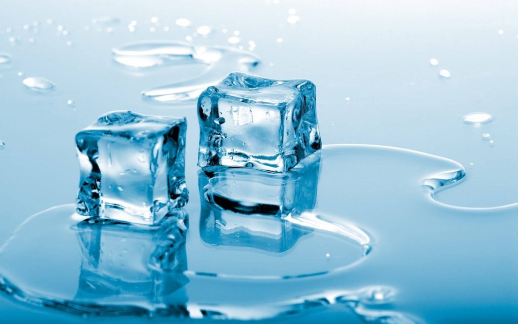 Macro photo of two melting ice cubes on reflective blue surface with water puddles wallpaper