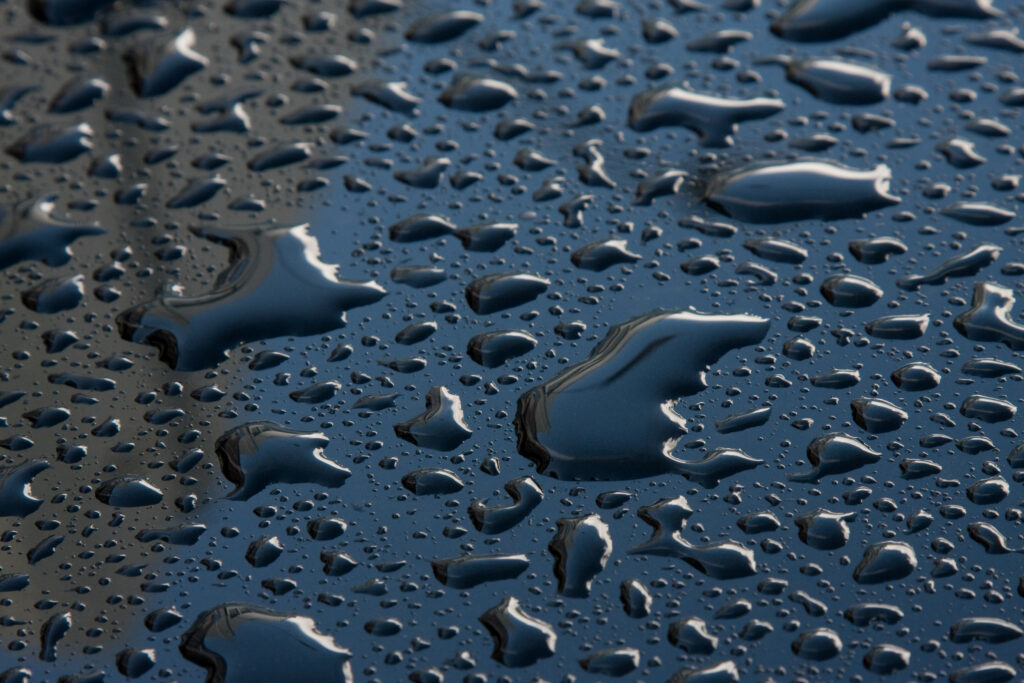 Refreshing Macro Water Droplets on Smooth Blue Surface Wallpaper