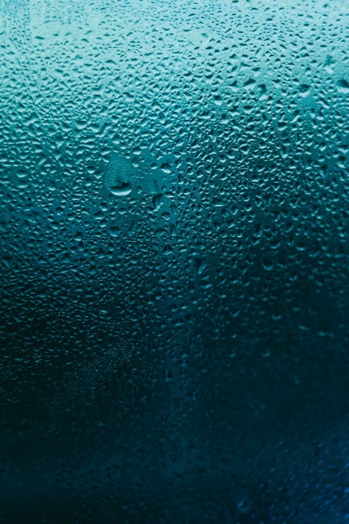 Serene Blue Macro Wallpaper: Water Droplets on Glass Surface