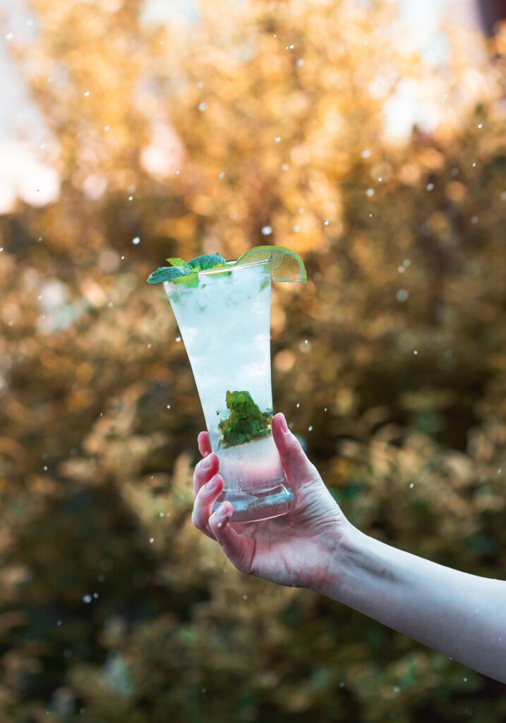 “Refreshing Mojito in Hand: Mint, Lime & Ice Wallpaper Background”