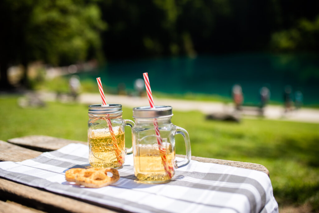 Refreshing Mason Jar Drinks on Checkered Cloth - Serene Lakeside Wallpaper