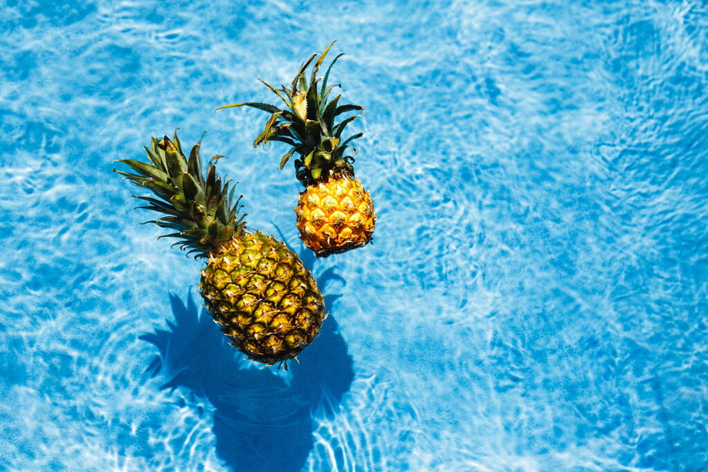 Sun-Kissed Summer Delight: A Refreshing Dip with Pineapple Bliss Wallpaper