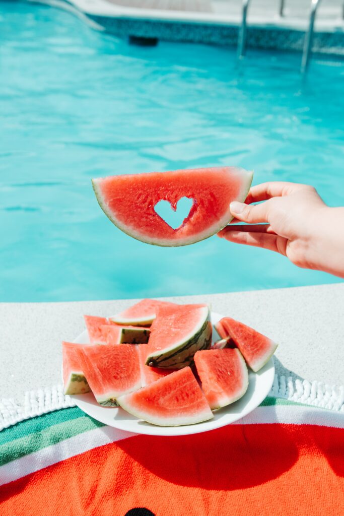 Refreshing Summer Wallpaper: Watermelon Slice by the Poolside