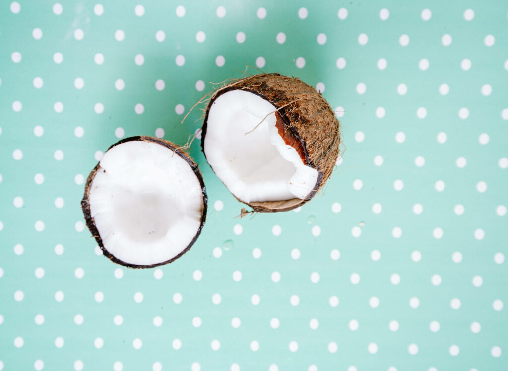 Tropical Coconut Wallpaper: Close-Up on Halved Coconut & Pastel Green