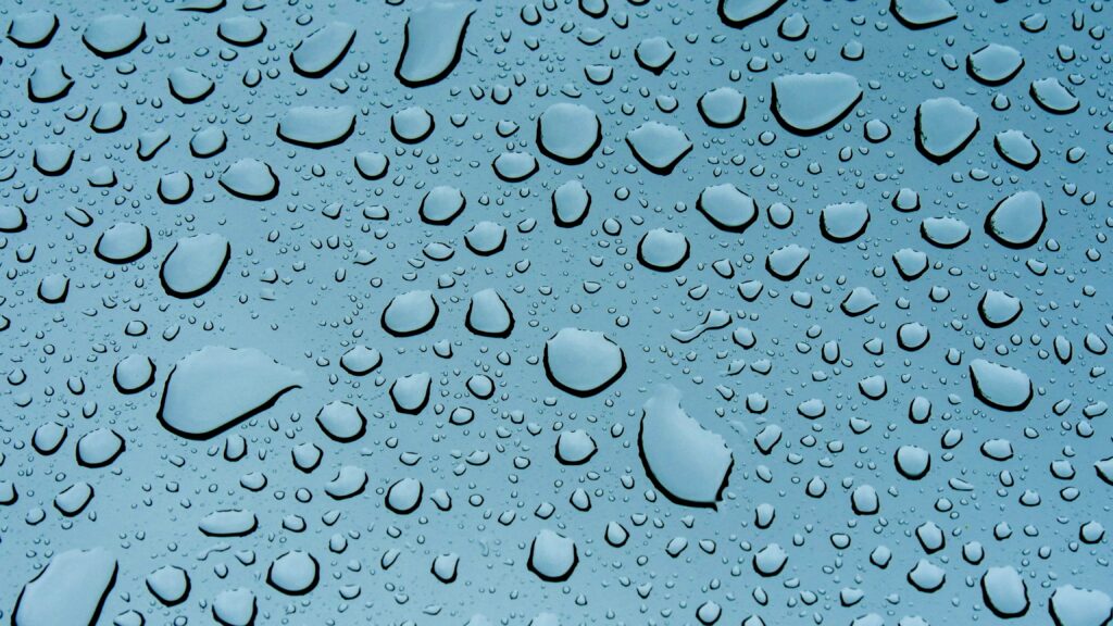 Refreshing Water Drops on Textured Surface - Detailed Wallpaper Background