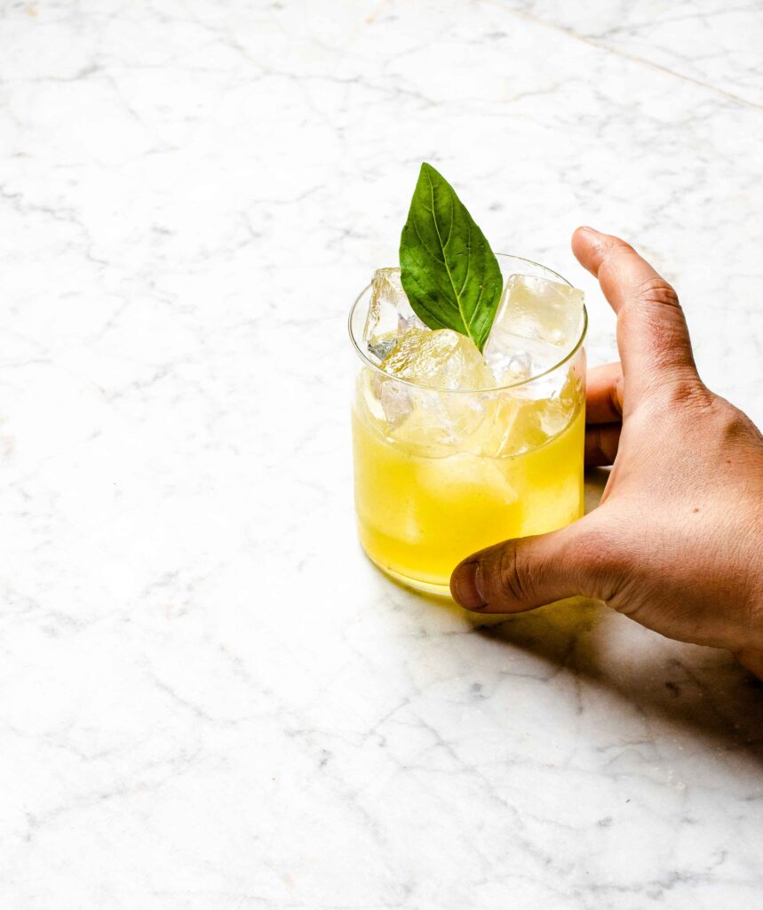 Refreshing Yellow Cocktail with Mint on Marble Background Wallpaper
