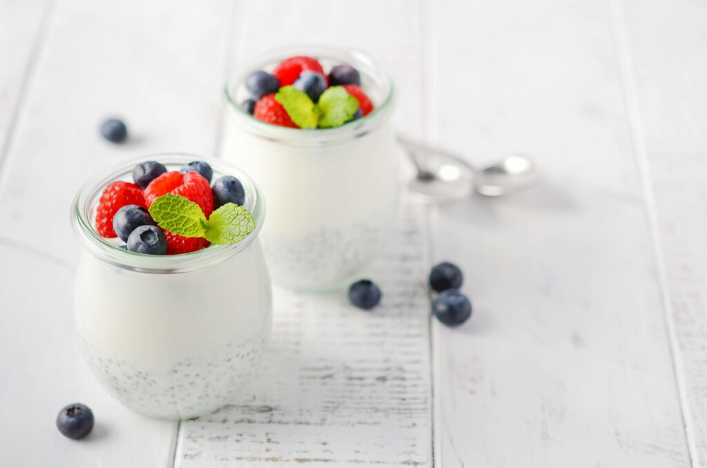 Vibrant Berry Yogurt Jars Wallpaper - Rustic White Background
