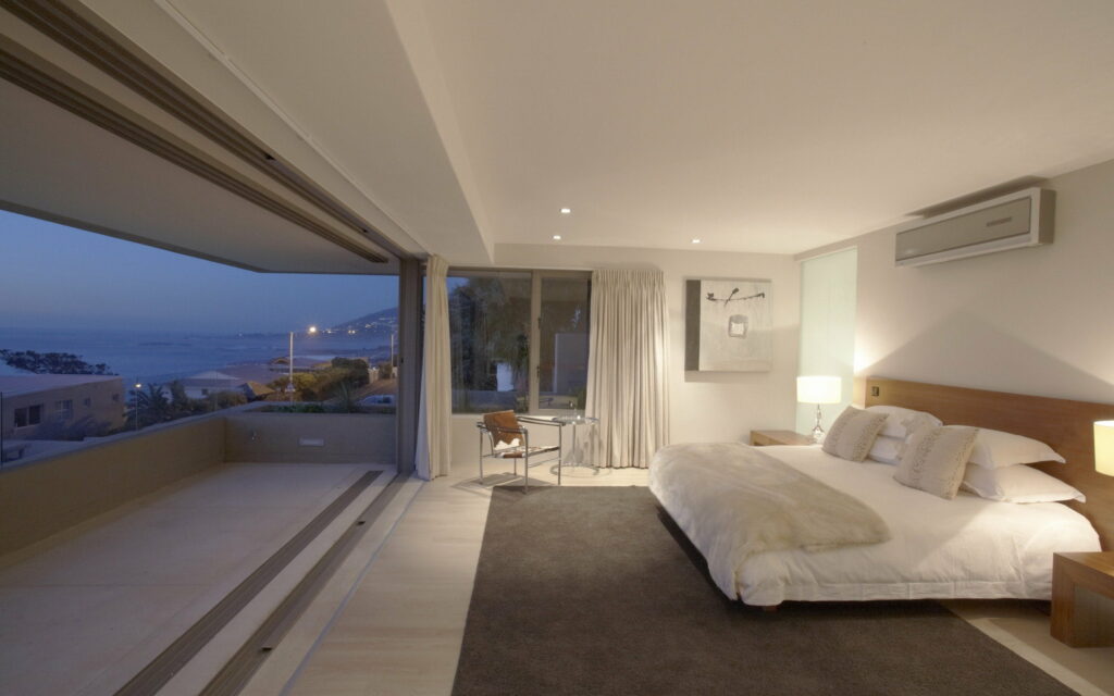 Serene White Room with Breathtaking Blue Sky View Wallpaper