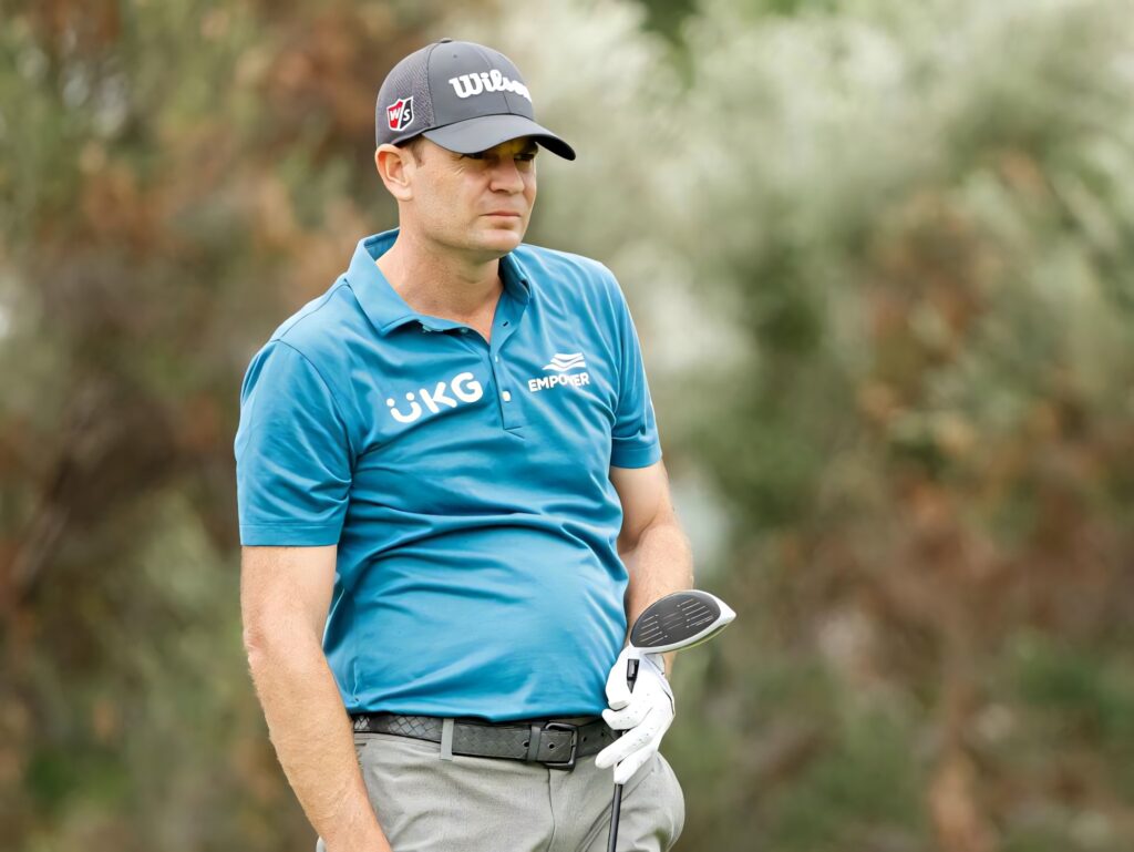 Brendan Steele professional golfer in blue polo and Wilson hat on golf course relaxed stance Wallpaper